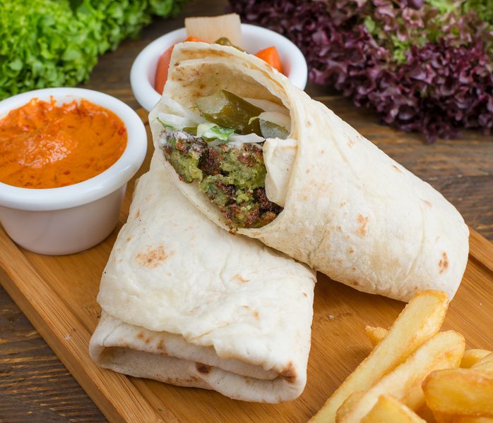 Falafel Veggie Wrap with tahini sauce and fresh herbs